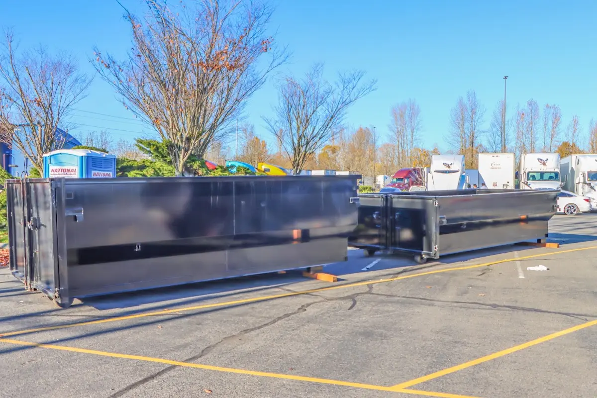 Professional dumpster rental service with roll-off container on residential driveway in Richmond Heights